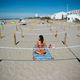 A woman sunbathes in a roped-off distancing zone on a beach in La Grande Motte, southern France, on May 21, 2020.